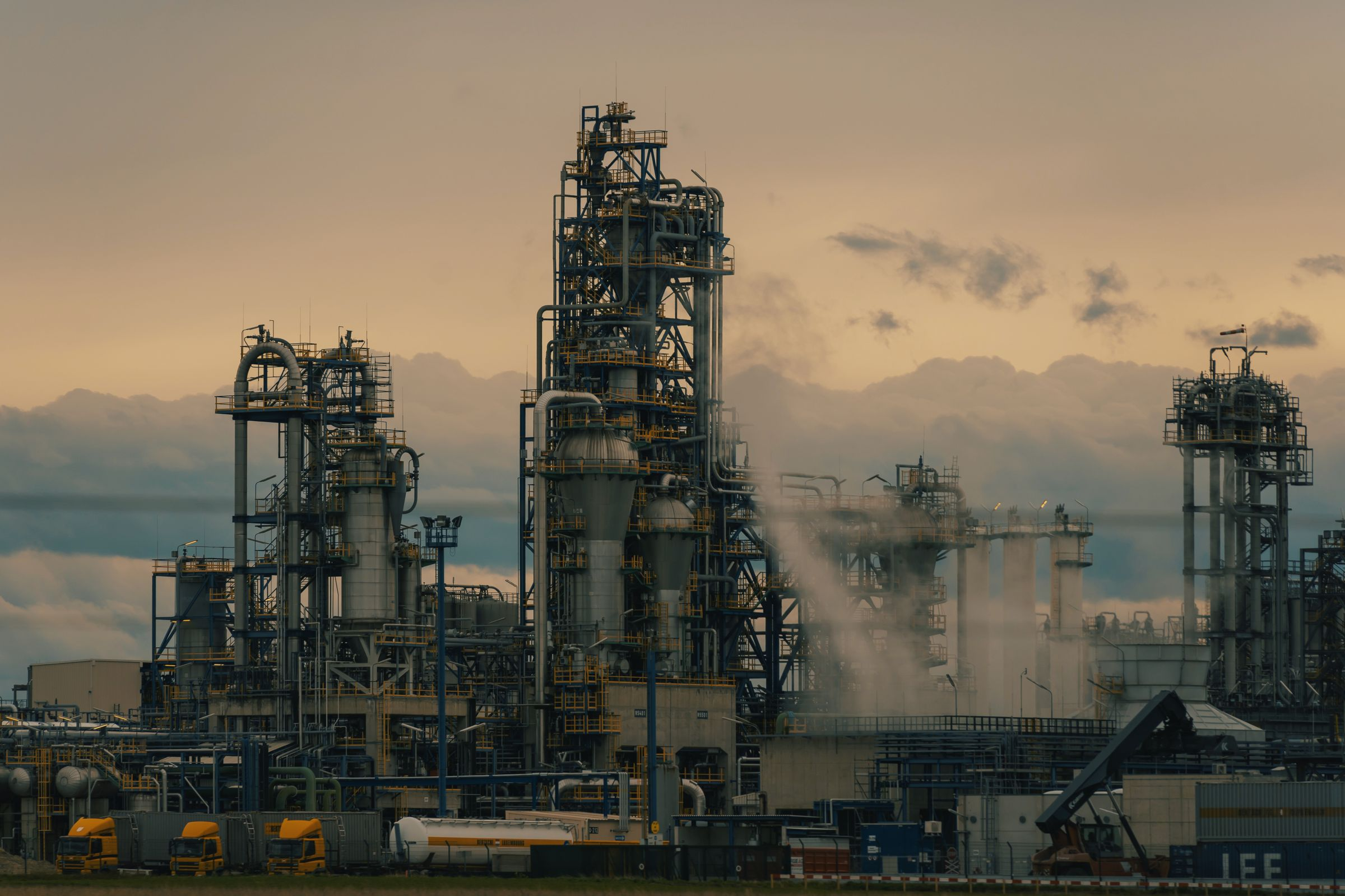 Refinery towers at dusk, illustrative