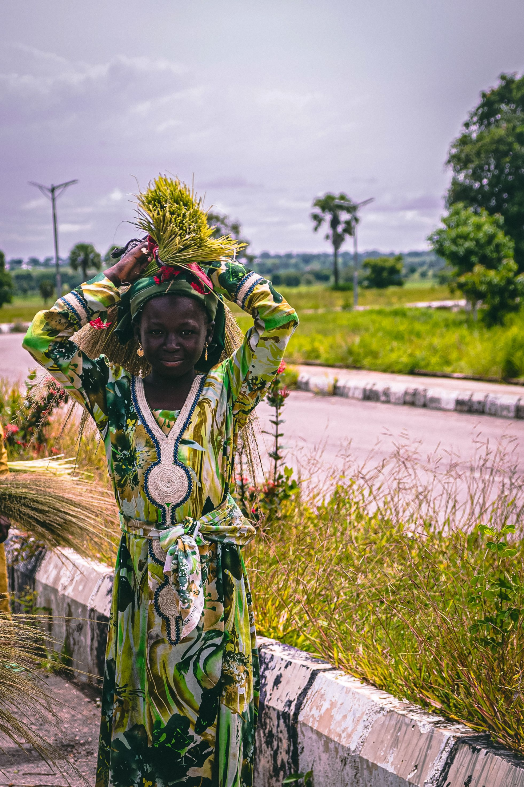 Woman carrying grass in green countryside