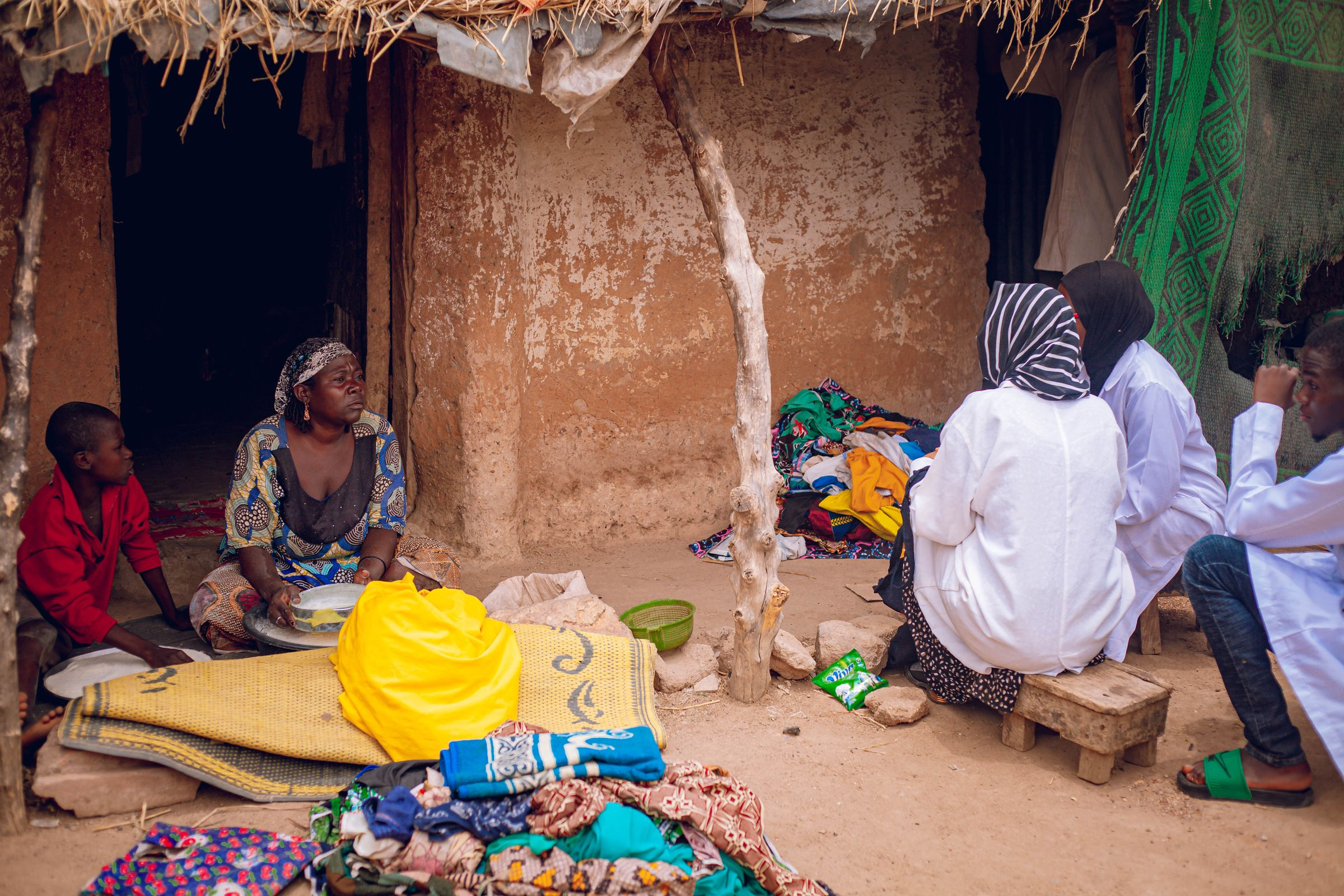 People gathering outside a home in Nigeria