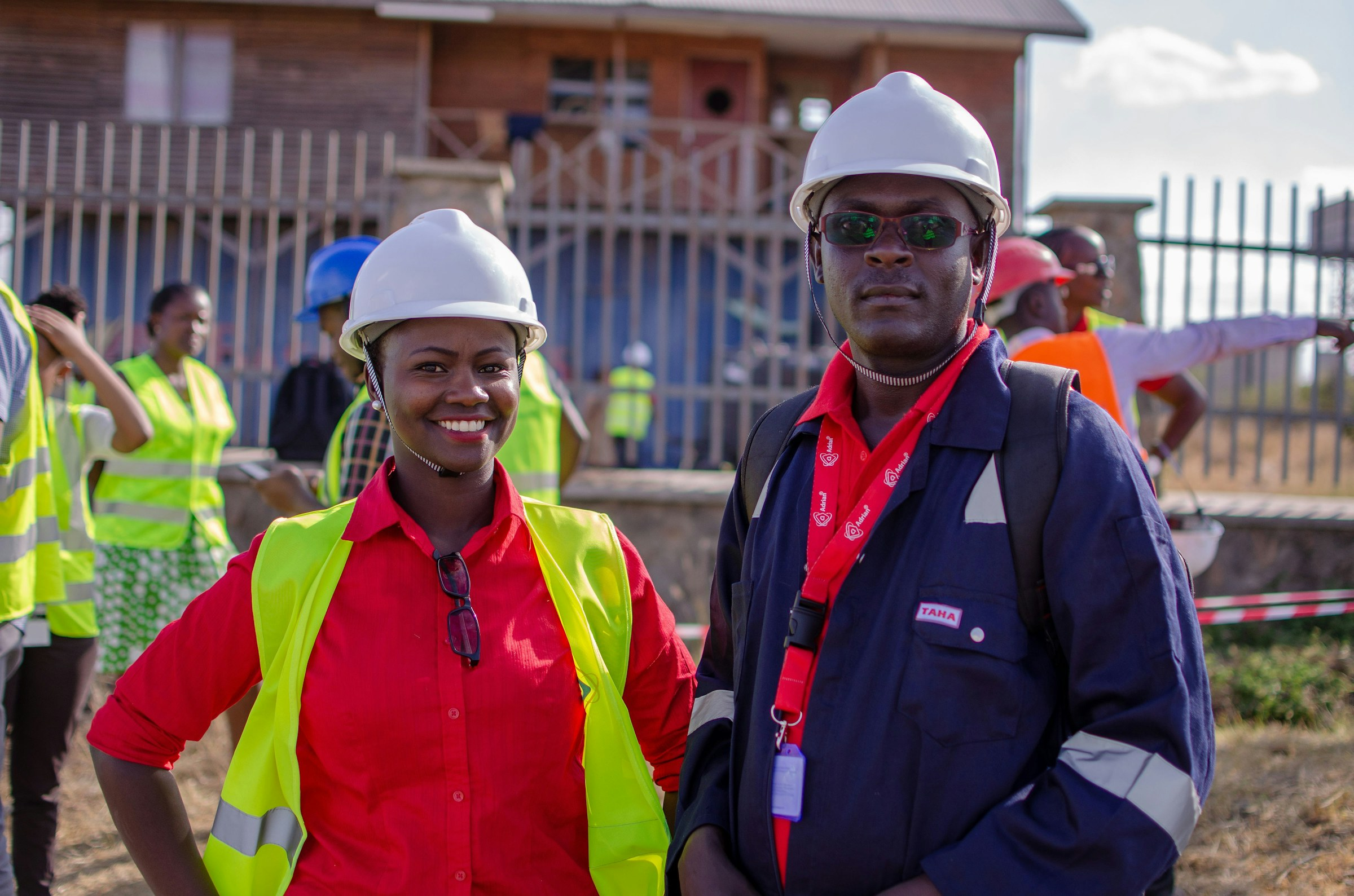 Field workers in hard hats and high-visibility vests