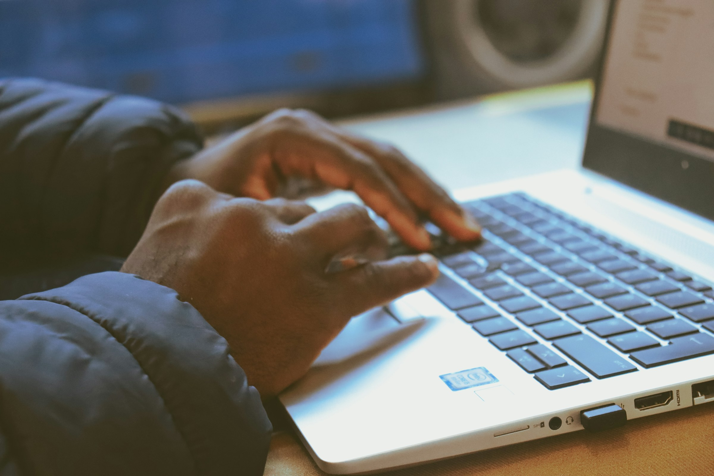 Hands working on a laptop