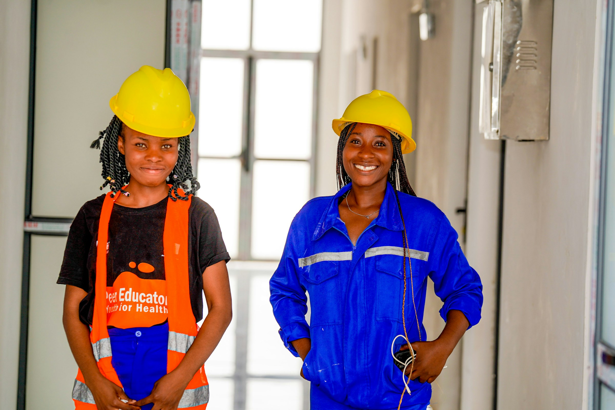 Two women in hard hats and workwear