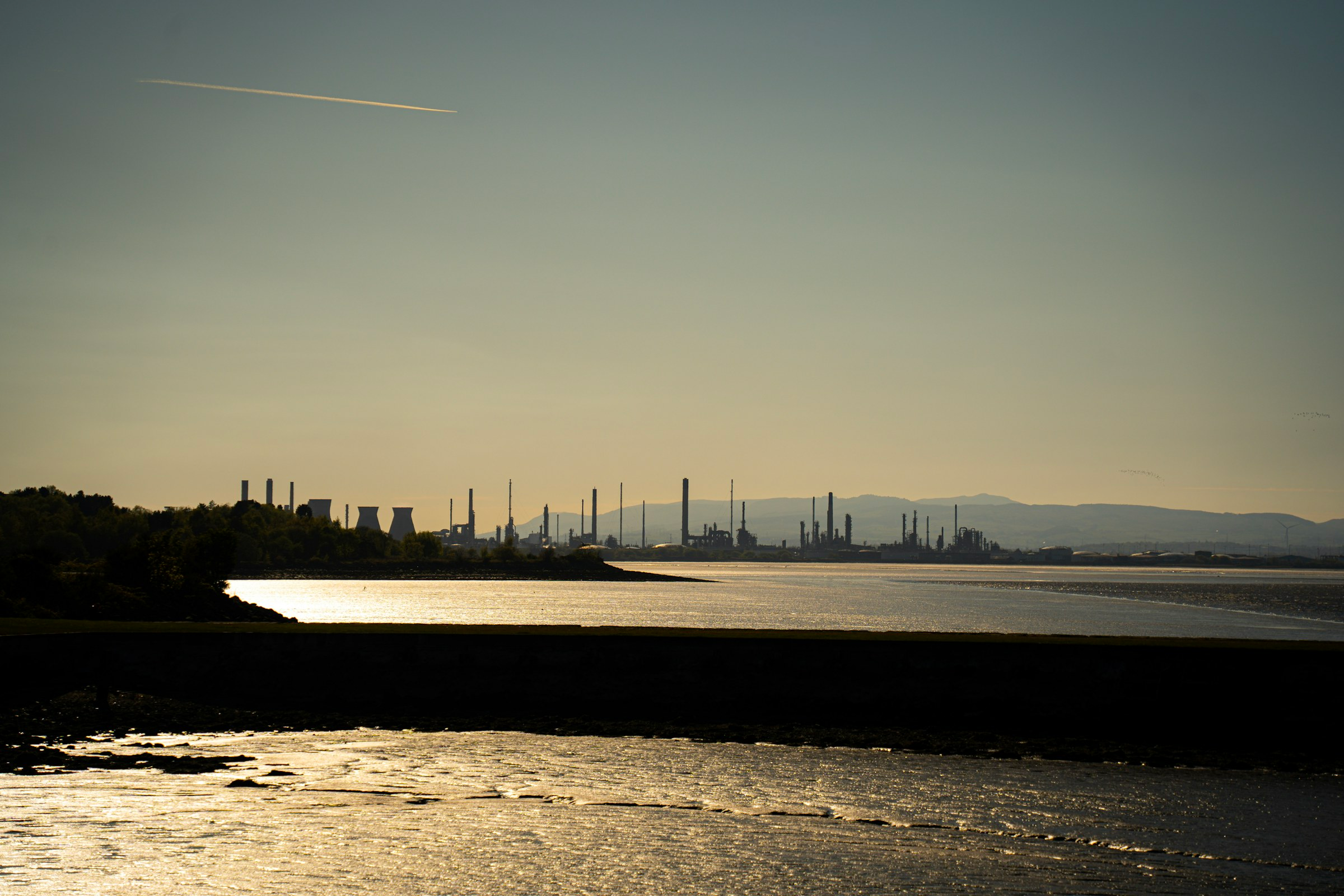 Coastal industrial landscape at dusk, illustrative
